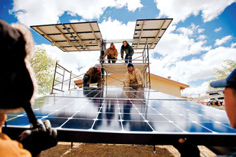 A crew from Positive Energy installs solar panels at the Crownpoint Chapter House on Friday morning. With the addition of the solar panels the, chapter house will now gather it's electricity solely from the sun.  © 2011 Gallup Independent / Brian Leddy 